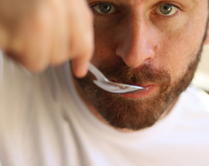 a man is brushing his teeth with a toothbrush