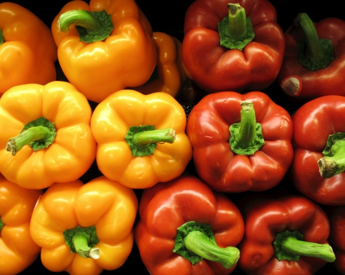 a pile of red, yellow and green peppers