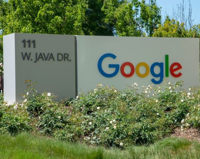 a google sign in front of some bushes and trees