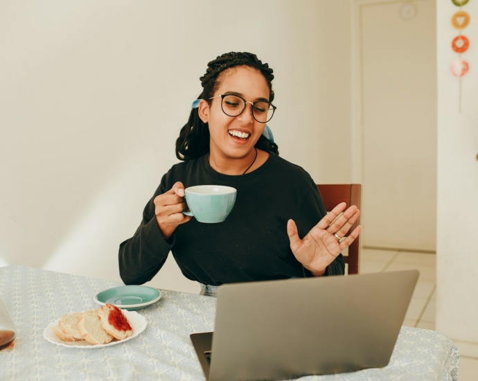 woman in black long sleeve shirt holding white ceramic mug