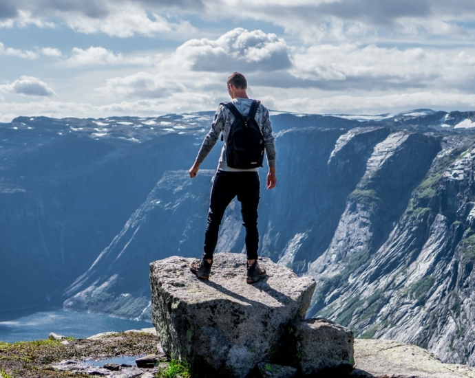 man standing on edge of cliff