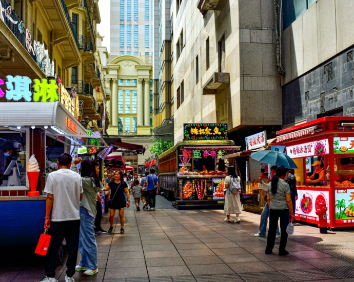 A group of people standing around a food truck