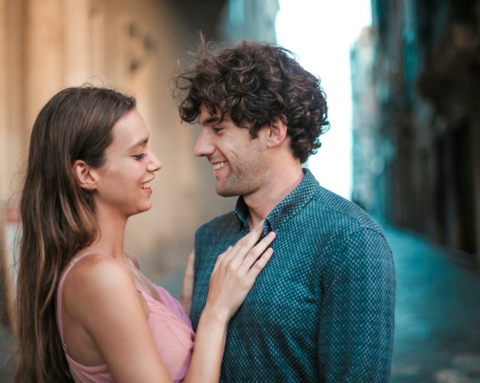 Man Wearing Blue Shirt Kissing Woman in Pink Tank Top