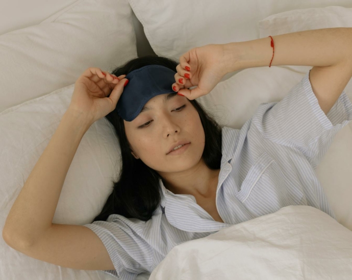 Woman in a Sleep Mask Waking up in her Bed