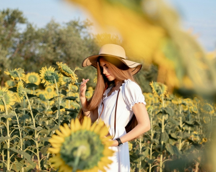 A woman standing in a field of sunflowers