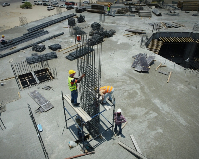 a group of men standing on top of a construction site