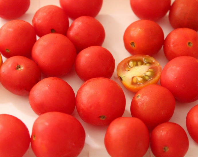 red tomato on white table