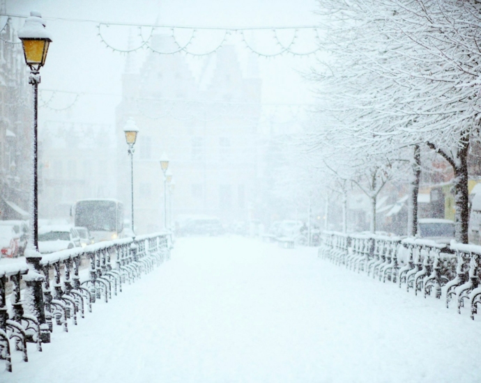 road covered by snow near vehicle traveling at daytime