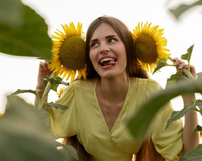 A woman standing in a field of sunflowers