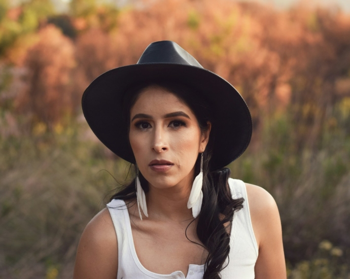 A woman wearing a black hat and a white shirt