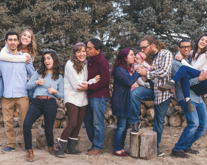 People Standing in Front of Wood Pile