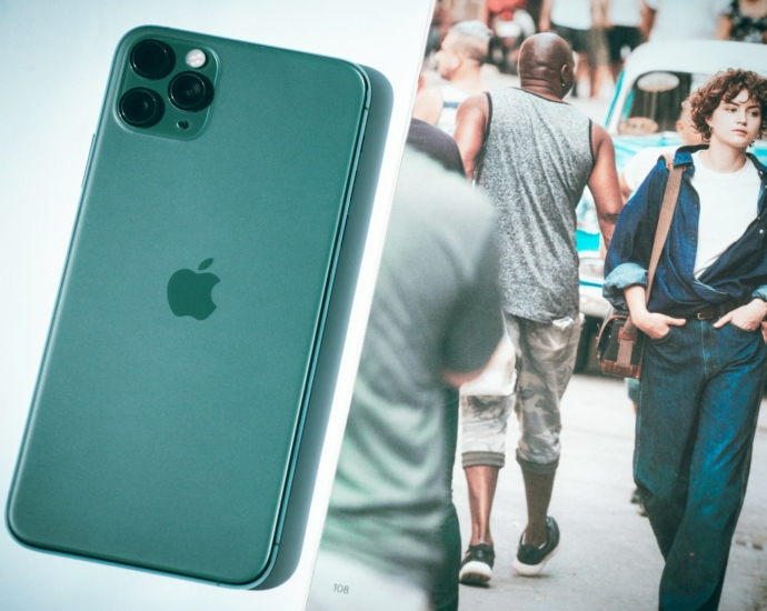 a picture of a man walking down a street next to a cell phone