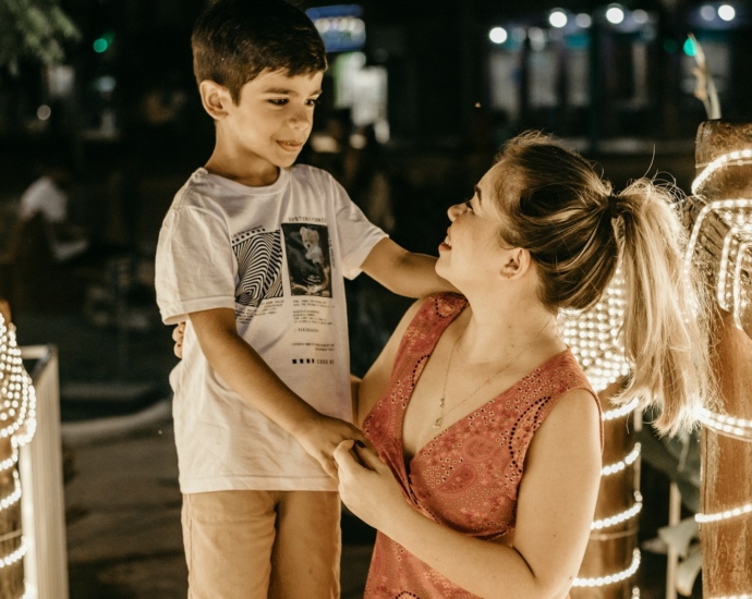 a woman and a boy standing next to each other