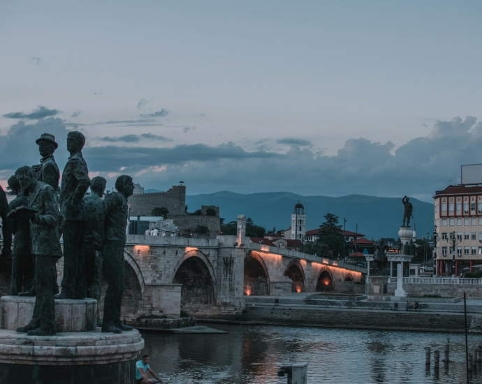 a group of statues by a river