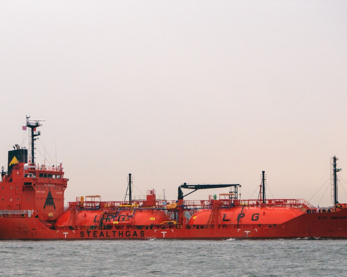 a large red boat floating on top of a body of water