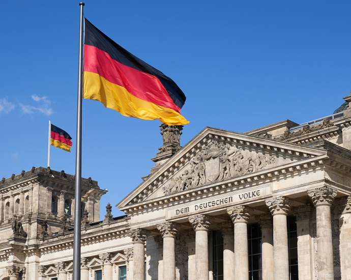 a german flag flying in front of a building