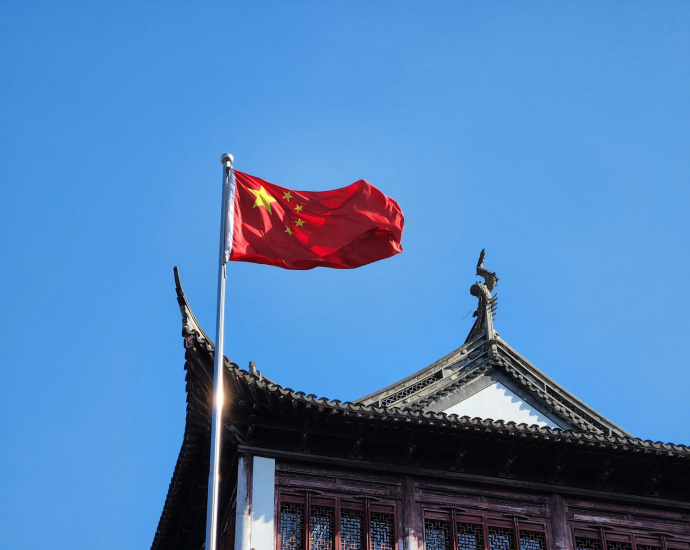 A chinese flag flying on top of a building