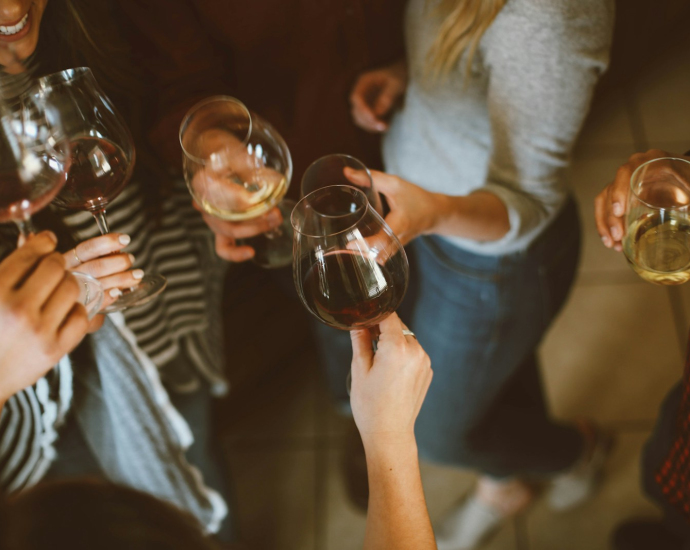 group of people tossing wine glass