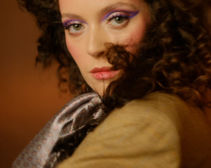 A close up of a woman with curly hair