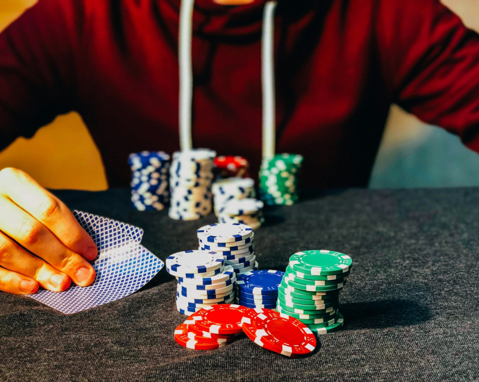 person sitting near poker chips