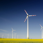 windmills on grass field at daytime