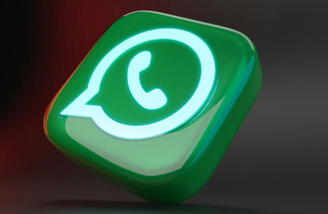 a green and white button with a phone on it