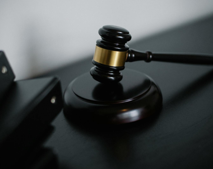 Close-up of a wooden gavel on a desk, symbolizing justice and legal authority.