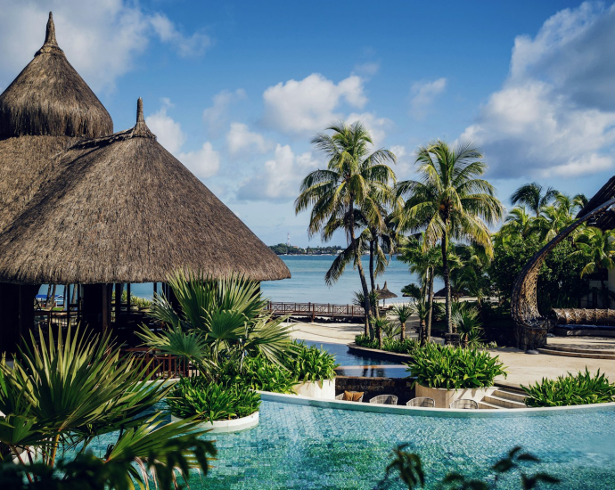 brown nipa hut near swimming pool during daytime