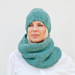 A woman wearing a scarf and a knitted hat