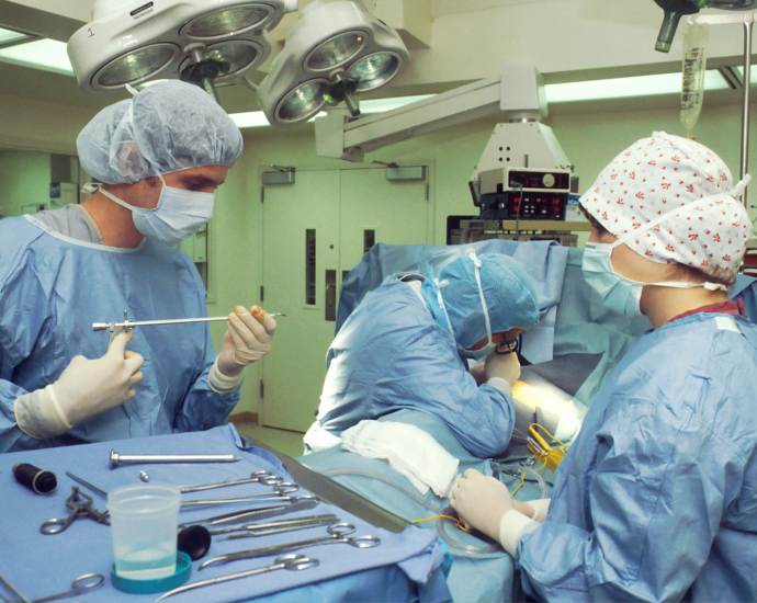 people in blue scrub suit sitting on chair