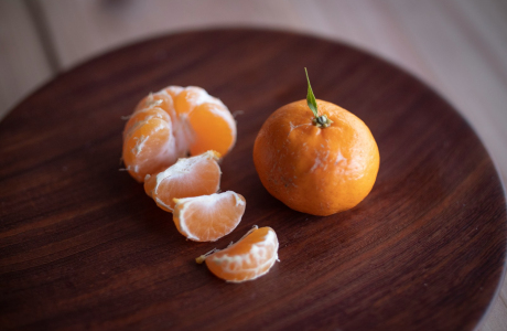 sliced oranges on brown wooden table