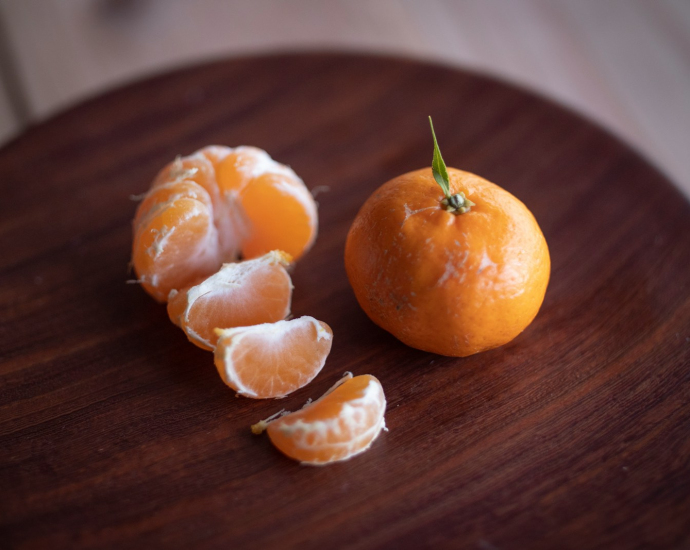 sliced oranges on brown wooden table