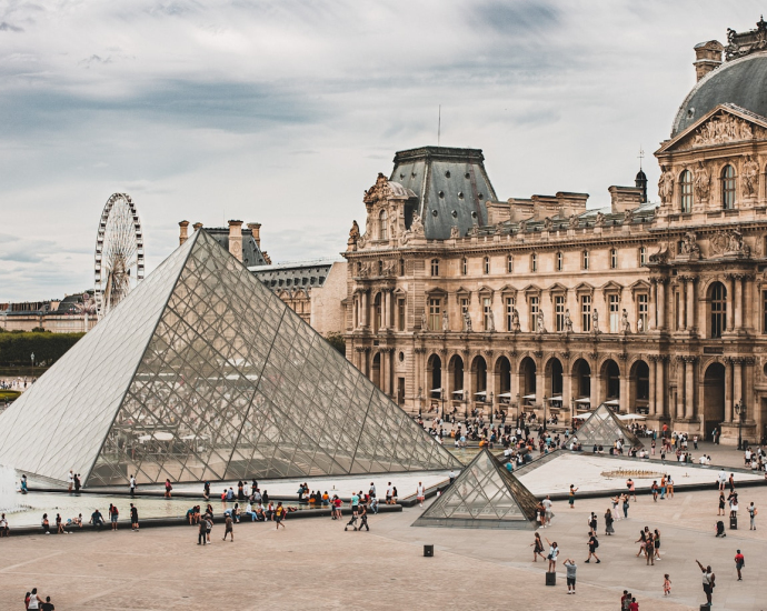 people gathering near Louvre Museum during daytime