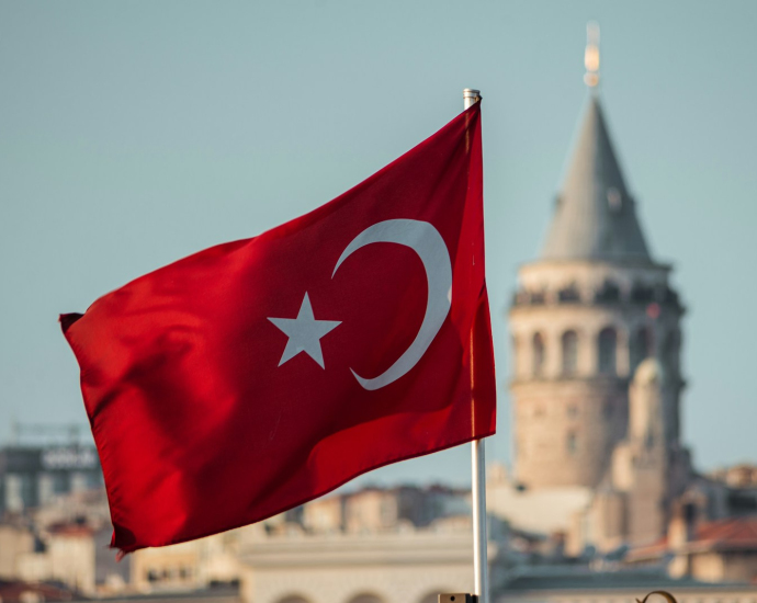 a turkey flag flying in front of a building