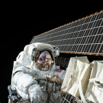 photography of Astronaut beside satellite