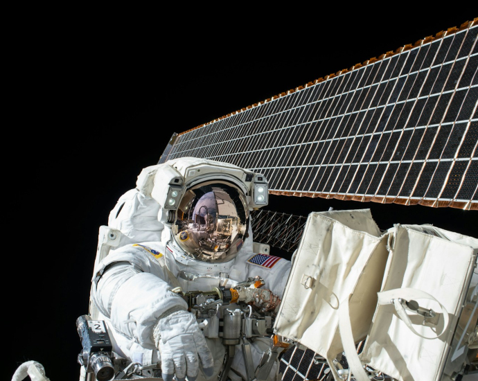 photography of Astronaut beside satellite