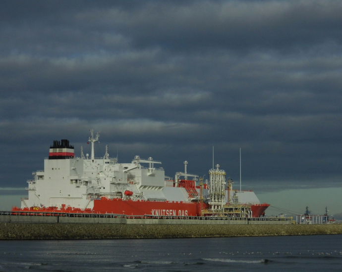 a large red and white ship in a body of water