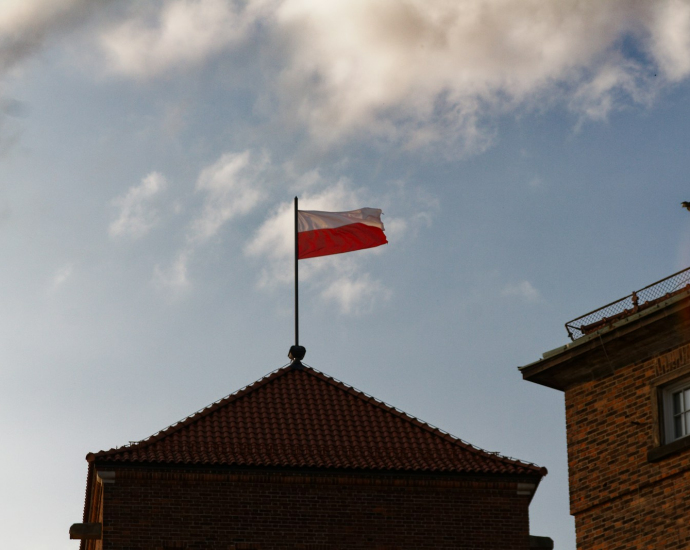 a red and white flag on top of a building