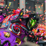 a colorful elephant is surrounded by confetti and streamers