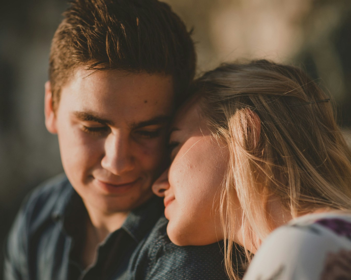 woman leaning on man's shoulder