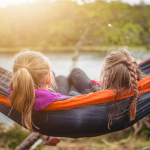 two women lying on hammock