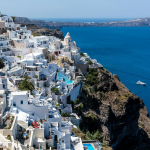 Explore breathtaking Santorini with white-washed buildings overlooking the Aegean Sea.