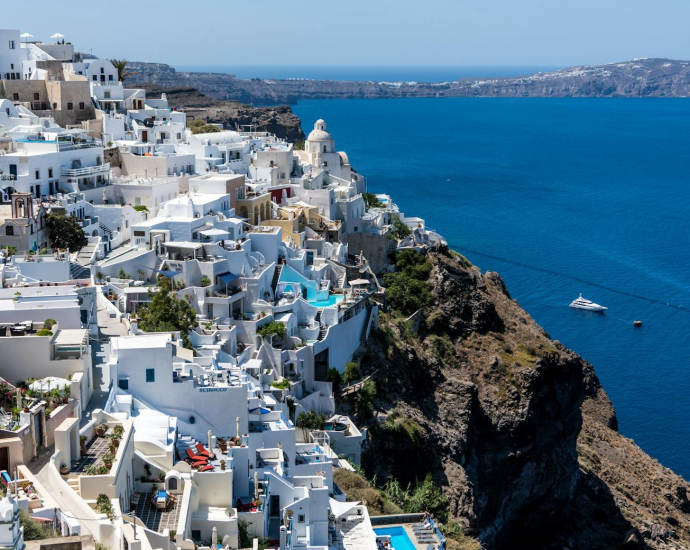 Explore breathtaking Santorini with white-washed buildings overlooking the Aegean Sea.