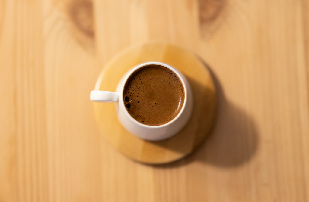 white ceramic mug with brown liquid