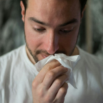 man wiping mouse with tissue paper