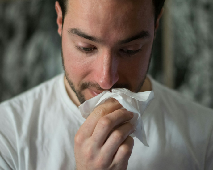 man wiping mouse with tissue paper