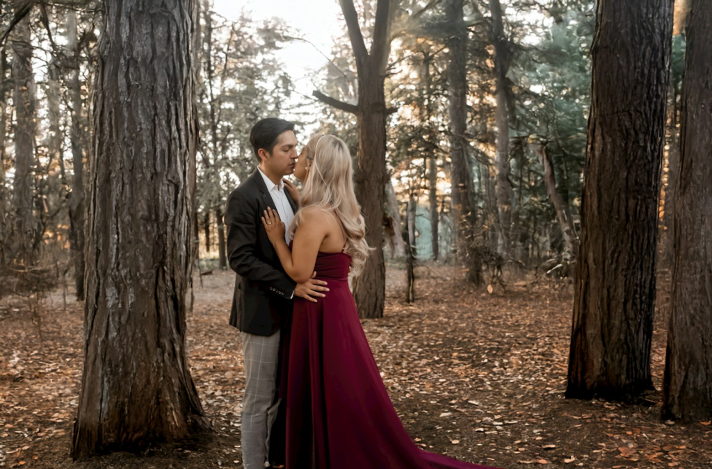 A man and a woman standing in the woods