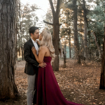 A man and a woman standing in the woods