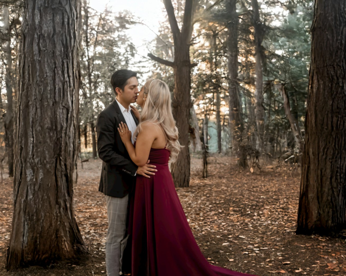 A man and a woman standing in the woods