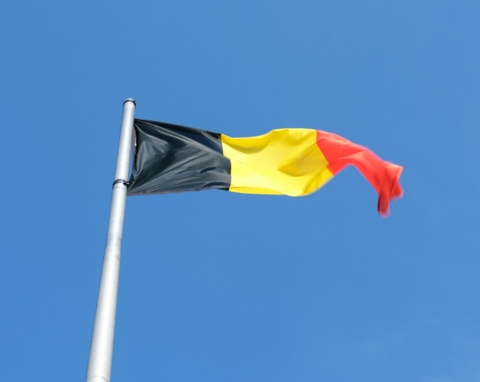 a black, yellow and red flag flying in the sky